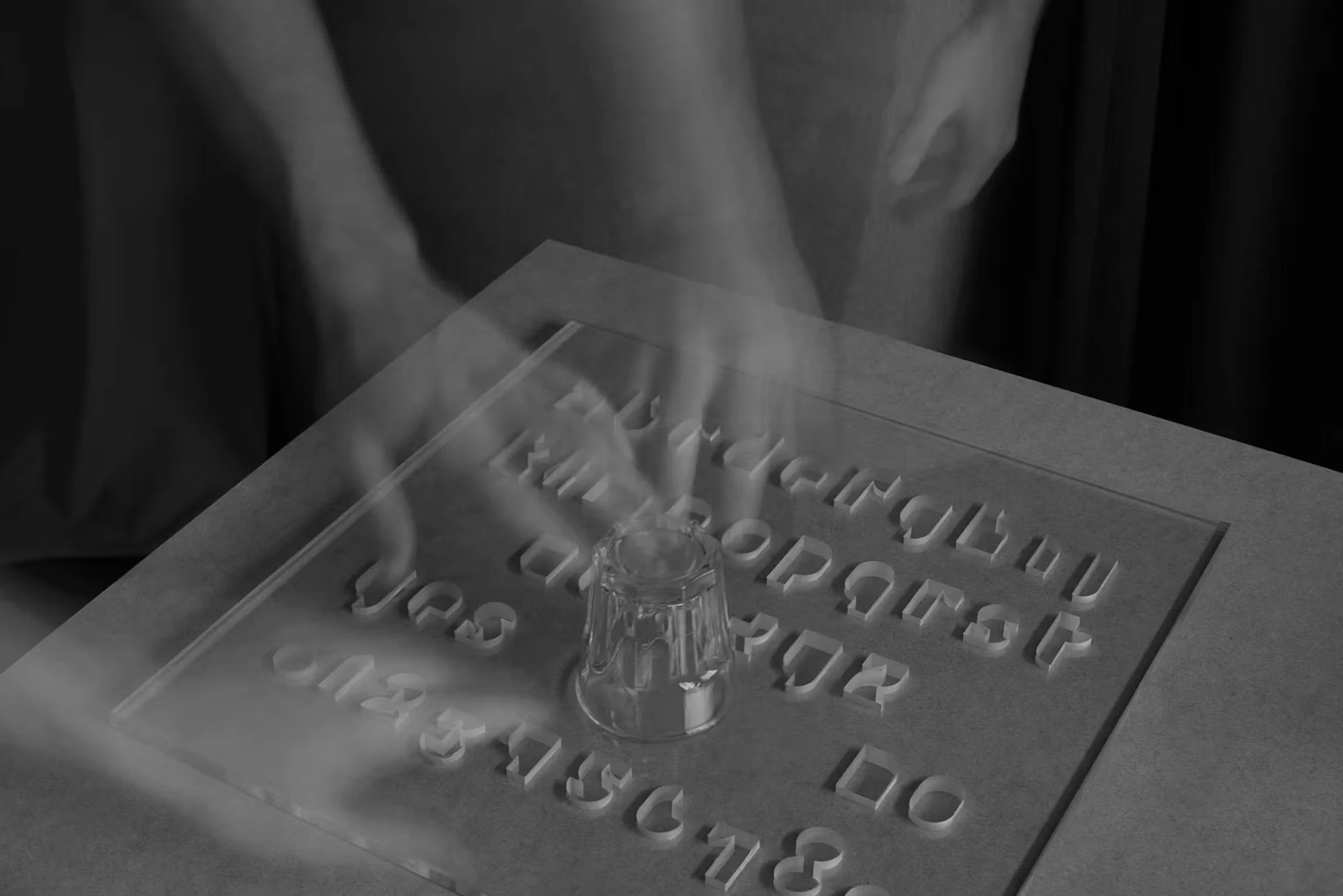 Hands moving above a spirit board assembled from typographic characters