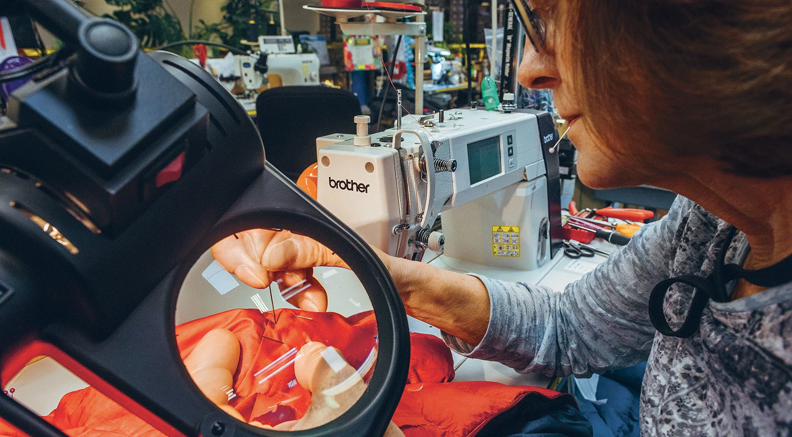 Susan Baker repairing a worn Patagonia jacket at the Reno repair centre